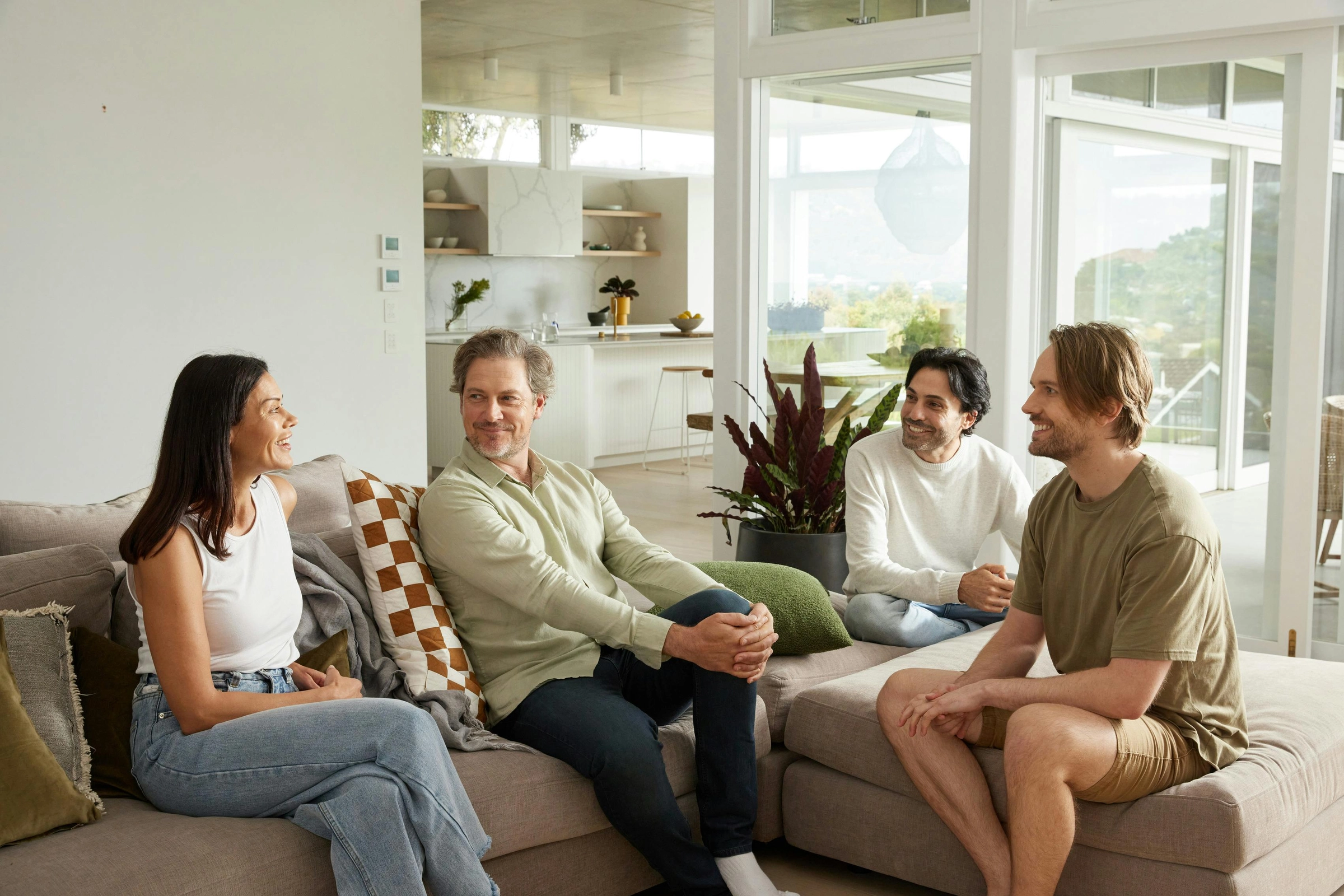 Group of men and women chatting on a sofa