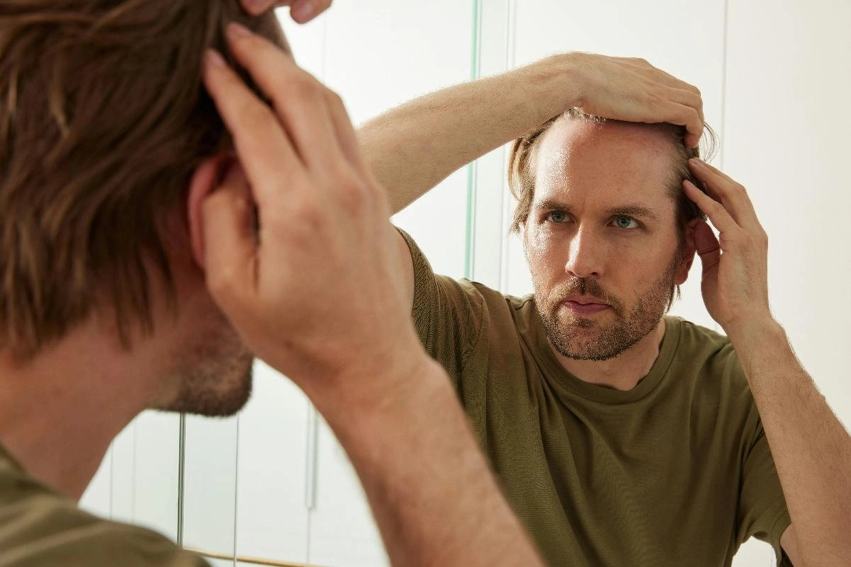 Man checking his hairline